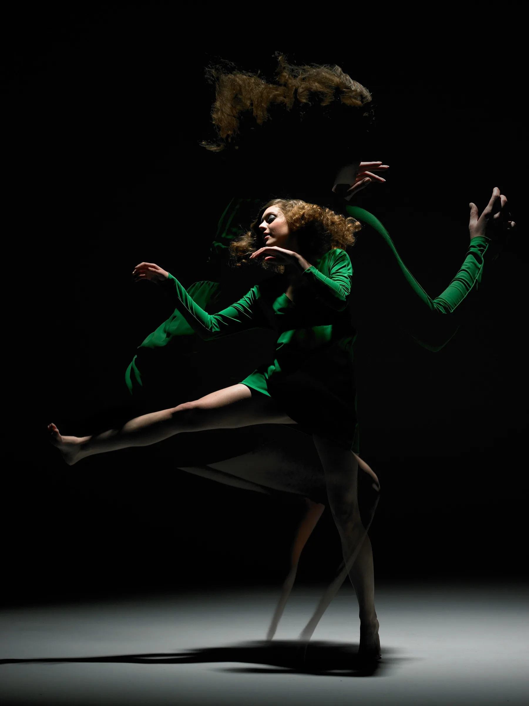 A dancer on a dark stage